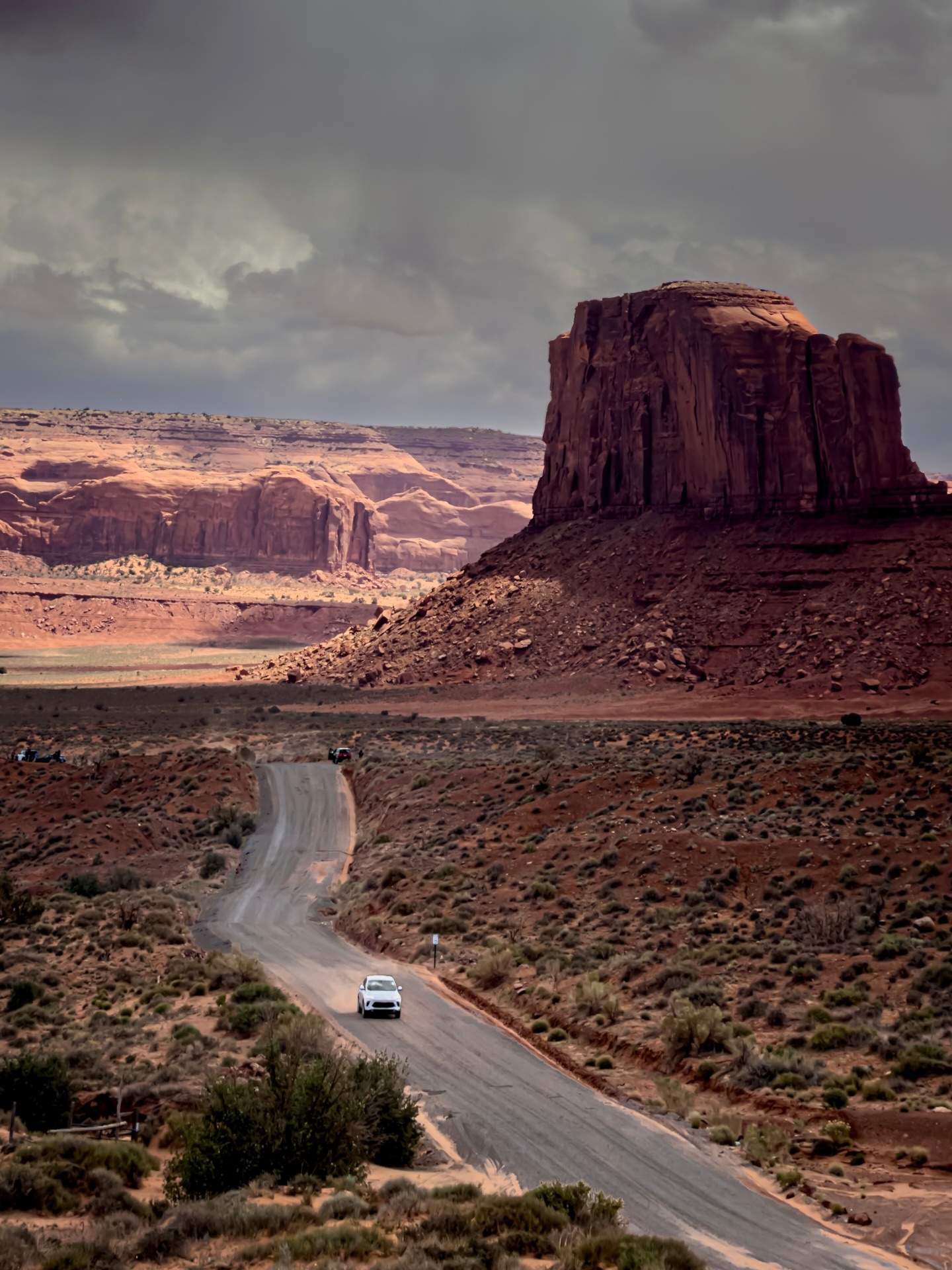 Dirt road past a red rock butte